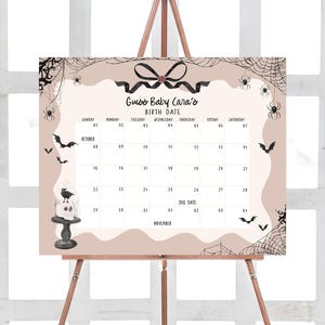 a calendar on a easel with a bow on it