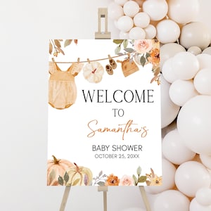 a welcome sign with balloons surrounding it