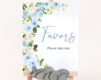 May include: A white sign with blue watercolor flowers and the text "Favors Please take one" on a wooden easel.
