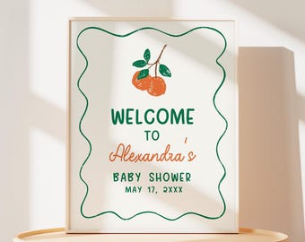 Puede incluir: Un cartel de bienvenida blanco con un borde verde y una ilustración verde y naranja de un naranjo. El texto en el cartel dice "Bienvenido a la Baby Shower de Alexandra el 17 de mayo de 2XXX".