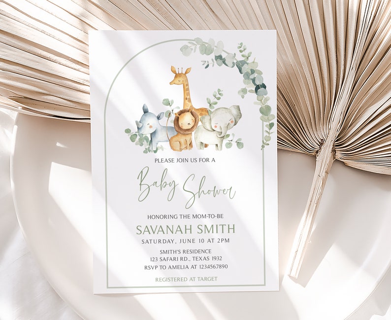May include: A baby shower invitation with a green and white border. The invitation features a watercolor illustration of a giraffe, lion, elephant, and rhinoceros. The text on the invitation reads "Please join us for a Baby Shower honoring the mom-to-be Savannah Smith, Saturday, June 10 at 2pm, Smith's Residence, 123 Safari Rd., Texas 1932, RSVP to Amelia at 1234567890, Registered at Target."