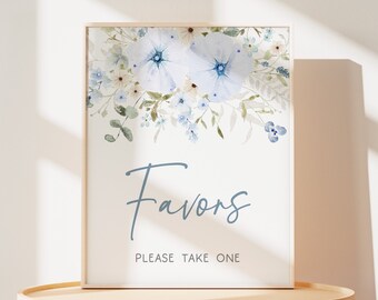May include: A white sign with a blue floral border and the text "Favors Please Take One".
