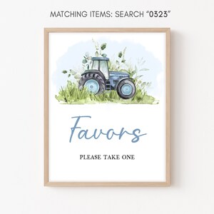 May include: A blue tractor with white wheels is surrounded by green grass and white flowers. The text "Favors" is written in blue script with the text "Please take one" below it.