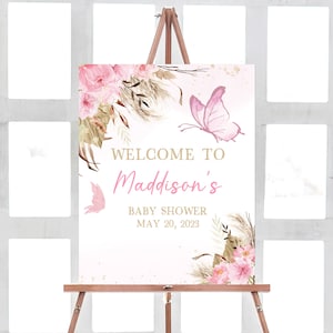 May include: Welcome to Maddison's Baby Shower sign with a pink and gold floral design and butterflies. The date of the shower is May 20, 2023.