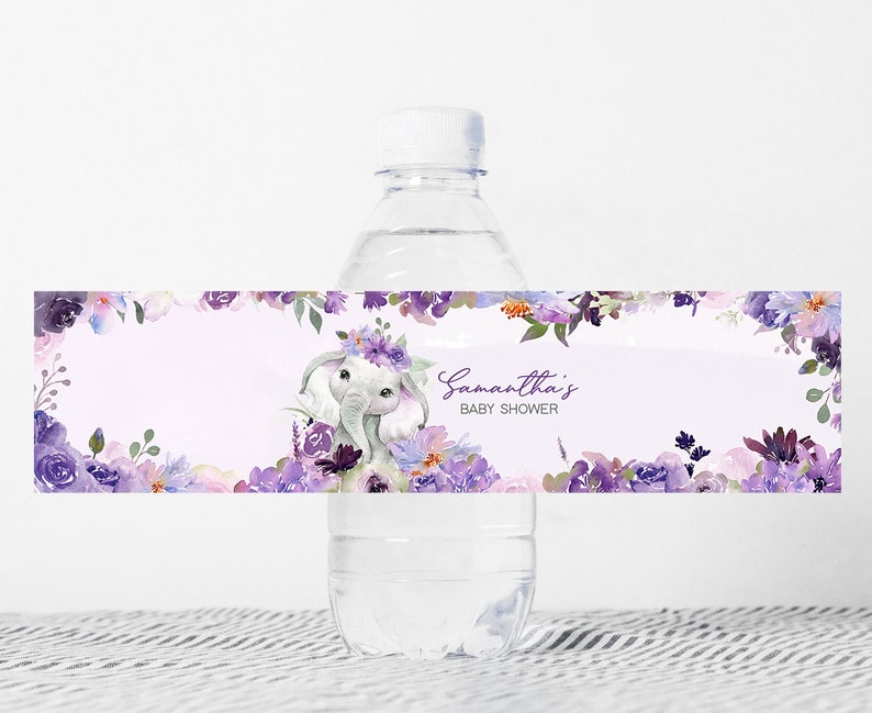 May include: Purple floral baby shower water bottle label with a cute elephant wearing a flower crown. The label says "Samantha's Baby Shower".