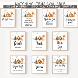 May include: A collection of ten rectangular signs featuring watercolor illustrations of a smiling pumpkin, a witch hat, and a crescent moon. Each sign displays black text with specific event instructions, including Late Night Diapers, Mom-osa Bar, and Diaper Raffle, set against a white background with a thin wooden frame.