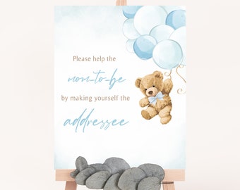 May include: A blue and white baby shower sign with a teddy bear holding balloons. The sign says "Please help the mom-to-be by making yourself the addressee".