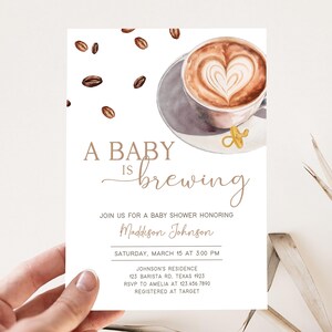 May include: A baby shower invitation with a coffee cup illustration and the text "A Baby is Brewing". The invitation includes the date, time, location, and RSVP information for the event.
