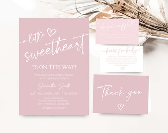 May include: A pink baby shower invitation with white text. The invitation reads "a little sweetheart is on the way!" and includes the date, time, and location of the shower. There are also cards for a diaper raffle and books for baby.