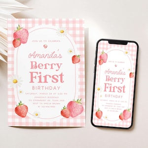 a pink and white birthday card next to a cell phone