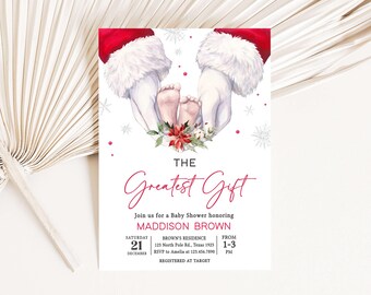 Peut inclure: Une invitation à une baby shower avec une illustration à l'aquarelle. Les mains du Père Noël bercent les pieds d'un bébé, avec le texte "The Greatest Gift". L'invitation comprend les détails de la baby shower de Maddison Brown.