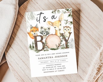 May include: It's a Boy baby shower invitation with a watercolor illustration of a deer, fox, raccoon, and owl. The invitation includes the text "It's a Boy" in brown letters with a woodgrain texture. The text also includes the date, time, and location of the baby shower.