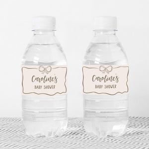 two water bottles with labels on them sitting on a table