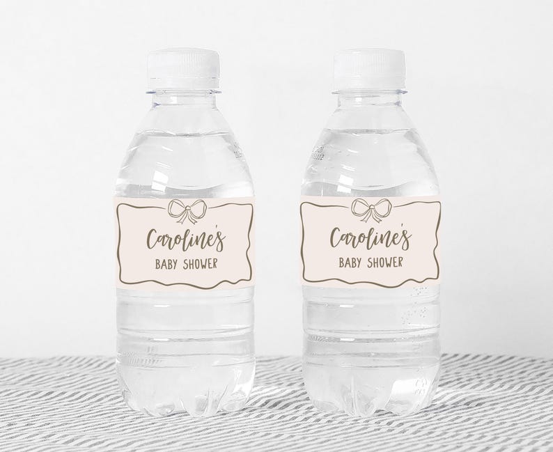 two water bottles with labels on them sitting on a table