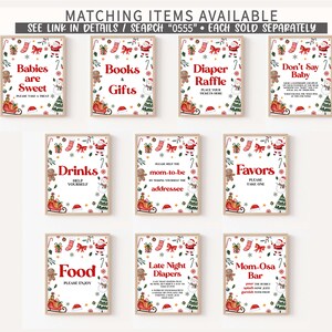 May include: A collection of framed Christmas-themed signs with red and green accents. The signs feature festive text like "Babies are Sweet," "Books & Gifts," and "Diaper Raffle." Each sign has a decorative border with holiday elements.