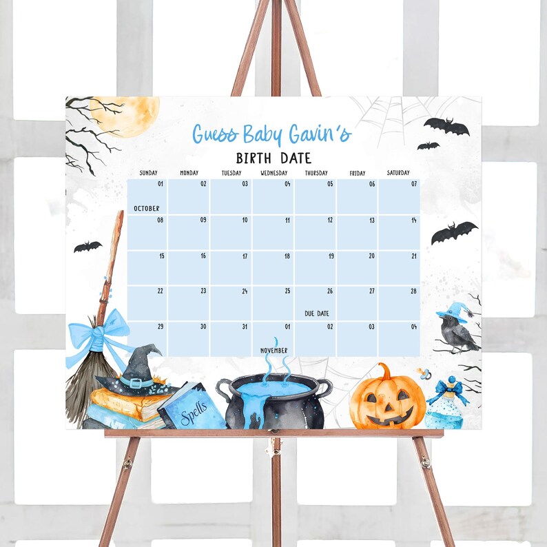 The image is a calendar for a baby's birthday, featuring Halloween-themed illustrations and decorations.