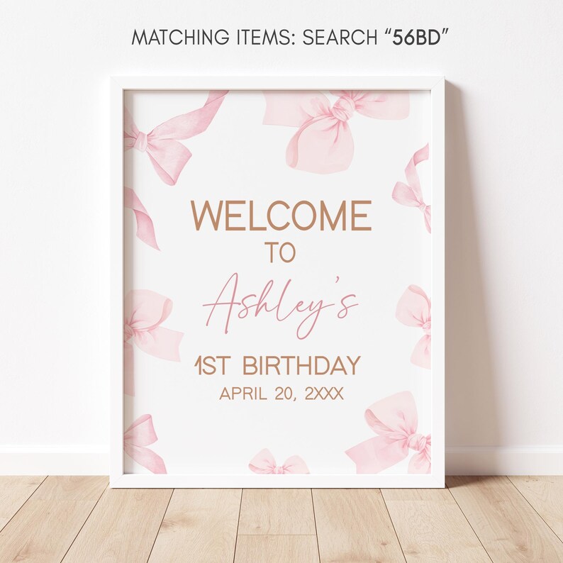 a pink and gold welcome sign on a white wall