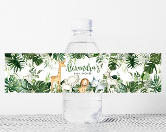 May include: Water bottle label with a jungle theme. The label features a giraffe, elephant, lion, and zebra surrounded by green leaves. The text on the label reads "Alexandra's Baby Shower".