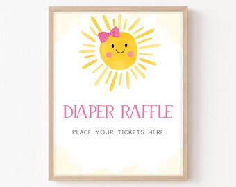 May include: A yellow sun with a pink bow on top and a smiling face. The text "Diaper Raffle" is written in pink letters below the sun. The text "Place your tickets here" is written in black letters below the text "Diaper Raffle".