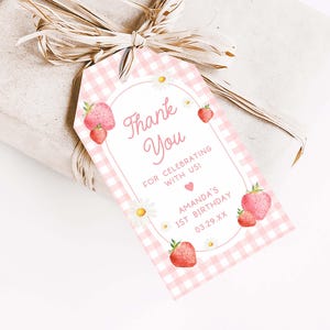 a pink and white checkered gift tag with strawberries on it