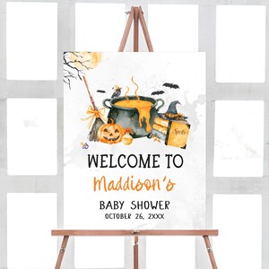 The image is a Halloween-themed welcome sign for a baby shower.
