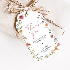 a gift wrapped in brown paper with a tag on it