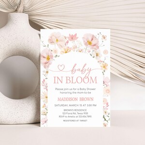 a baby in bloom baby shower is displayed next to a vase