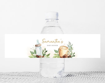 May include: Water bottle label with a gold and white design. The label features a coffee cup with a heart design, a baby bottle, and the text "Samantha's Baby Shower".