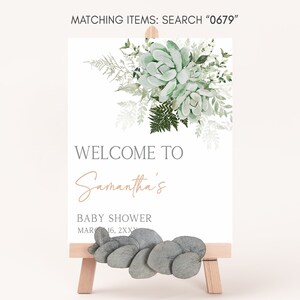May include: A welcome sign for a baby shower with a watercolor illustration of succulents and greenery. The sign says "Welcome to Samantha's Baby Shower MAR 16, 2XXX".