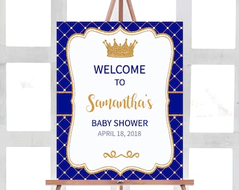Puede incluir: Un cartel de bienvenida azul y dorado para un baby shower. El cartel presenta una corona dorada, el texto "Bienvenido al baby shower de Samantha" y la fecha "18 de abril de 2018".