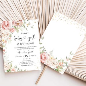 a white and pink wedding card with flowers on it
