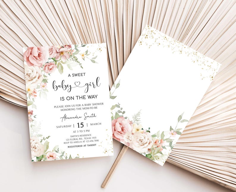 a white and pink wedding card with flowers on it