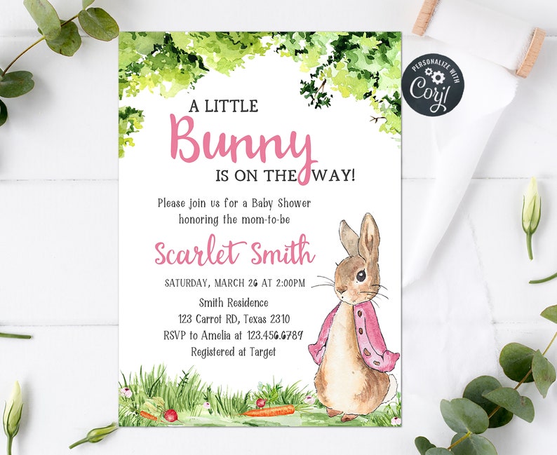 May include: A baby shower invitation with a watercolor illustration of a bunny rabbit wearing a pink jacket. The text reads "A Little Bunny Is On The Way!" and includes the date, time, and location of the shower.