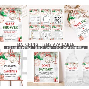 May include: A collection of baby shower decorations with a winter holiday theme. Includes invitations, game cards, a welcome sign, a 'Don't Say Baby' game, water bottle labels, and thank you tags. The designs feature ornaments, snowflakes, and festive colors.
