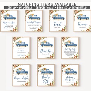 May include: A collection of framed signs with a watercolor illustration of a blue pickup truck carrying pumpkins. The signs have text for a baby shower, including "Momosa Bar," "Food," and "Favors." The signs are surrounded by floral accents.