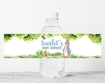 May include: Water bottle label featuring a watercolour illustration of a rabbit wearing a blue jacket, green foliage, and the text "Scarlet's Baby Shower".