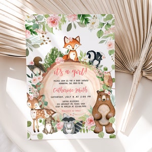 May include: It's a girl! Baby shower invitation with a woodland theme. The invitation features a pink and green floral border with a variety of woodland animals, including a fox, a squirrel, a raccoon, a deer, a bear, and an owl. The text on the invitation reads "It's a girl!" and includes the date, time, and location of the baby shower.