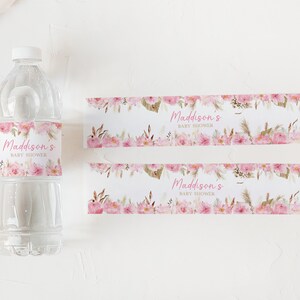 May include: Two pink and white floral water bottle labels with the text "Maddison's Baby Shower" in pink script.