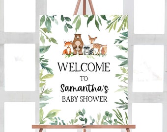 May include: Welcome to Samantha's Baby Shower sign with a watercolour green leafy border and a group of woodland animals including a bear, fox, deer, raccoon, and owl.