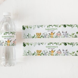 May include: Water bottle labels with a jungle theme. The labels feature a green leafy border with a white background. The text on the label reads "Samantha's Baby Shower". The labels also feature illustrations of a lion, giraffe, monkey, and rhinoceros.