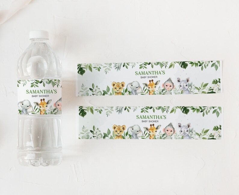 May include: Water bottle labels with a jungle theme. The labels feature a green leafy border with a white background. The text on the label reads "Samantha's Baby Shower". The labels also feature illustrations of a lion, giraffe, monkey, and rhinoceros.