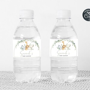 May include: Two clear plastic water bottles with personalized labels for a baby shower. The labels feature a watercolor illustration of a giraffe, a lion, and a zebra with greenery and the text "Savannah's Baby Shower".
