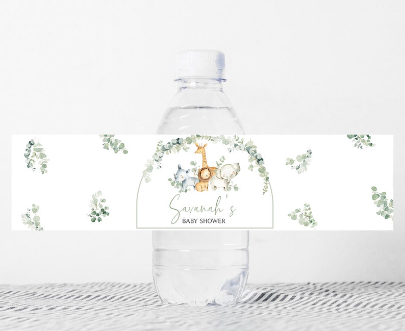 May include: Water bottle label with a watercolor design of a giraffe, lion, and elephant with eucalyptus leaves. The label says "Savannah's Baby Shower".