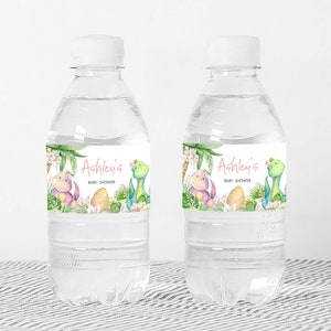 two water bottles with labels on them sitting on a table