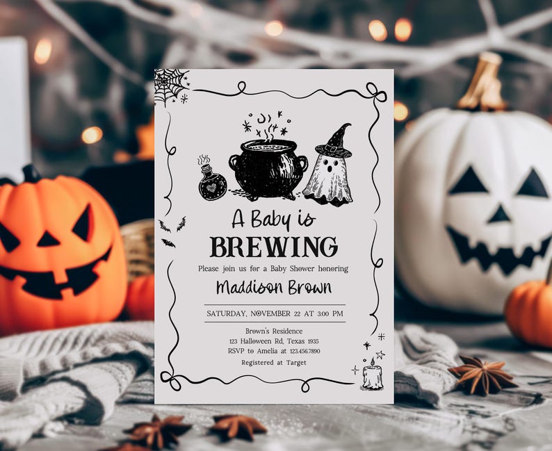 A Halloween-themed baby shower invitation featuring a pumpkin, ghost, and cauldron illustration, with the text "A Baby is BREWING Maddison Brown" and details about the event.