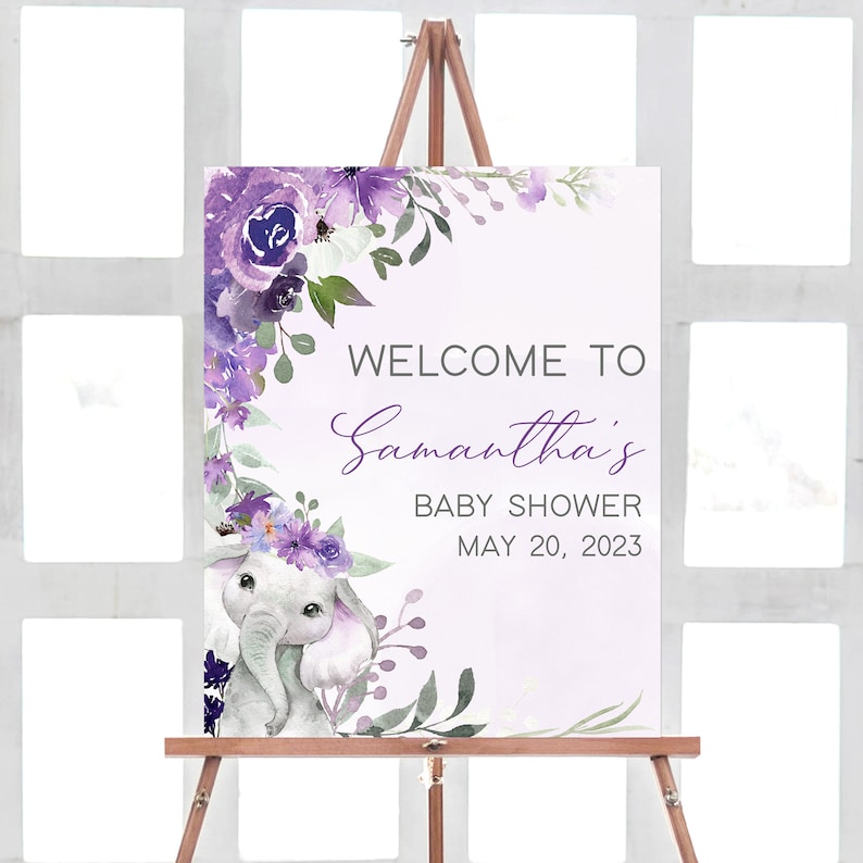 Op de afbeelding: Paarse en witte bloemige welkomstbord met een schattige olifant-illustratie. Het bord staat "Welkom op Samantha's Baby Shower 20 mei 2023".