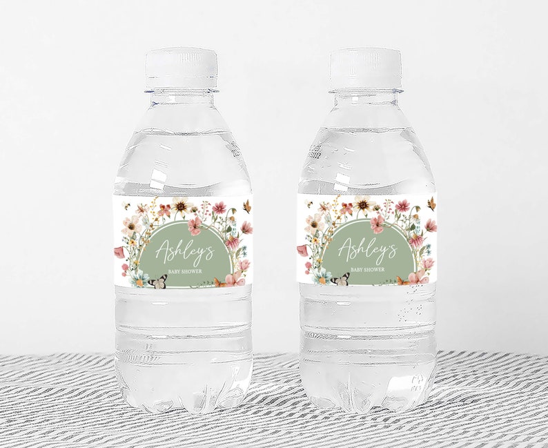 two water bottles with labels on them sitting on a table