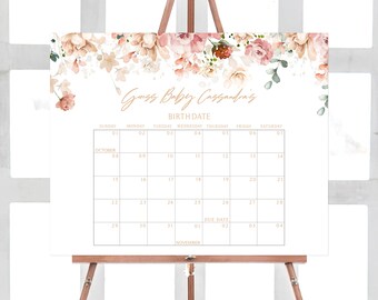 May include: A white calendar with a floral design at the top. The calendar is for October and November and has the text "Guess Baby Cassandra's Birth Date" at the top. The due date is highlighted in a light brown box.