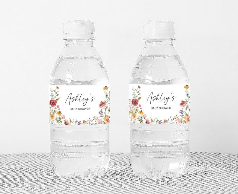 two water bottles with labels on them sitting on a table