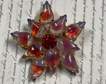 Unique star brooch with red and white stones. Christmas